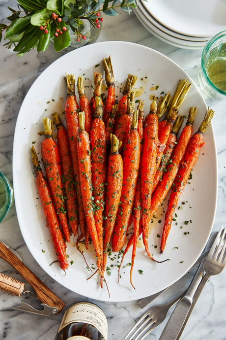 Honey glazed carrots roasted to perfection, tossed in butter + fresh herbs. The easiest (and tastiest) side dish to any meal!