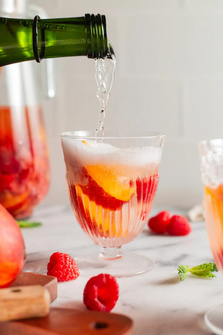 Crisp, light, refreshing white sangria with raspberries and peaches! Make ahead of time with just 5 ingredients, perfect for entertaining!